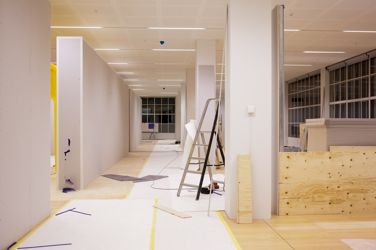 Image of a hallway with offices on both sides, currently in the midst of renovation.